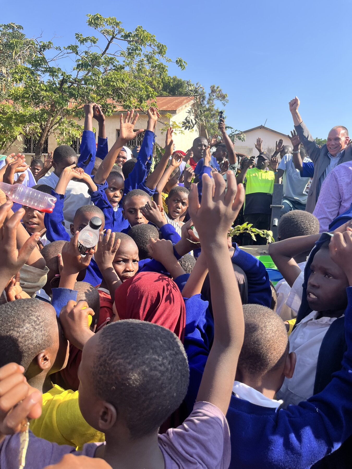 Tanzanian community celebrating a new water well dedication